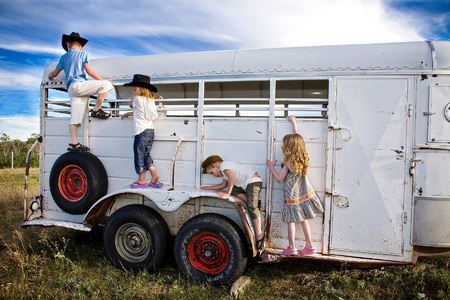 (Left to right) Tyler (age 6),  Frankie (age 5),  Jimmy (age 4) and Brilee (age 4) play on an old horse trailer
East Glacier, Montana