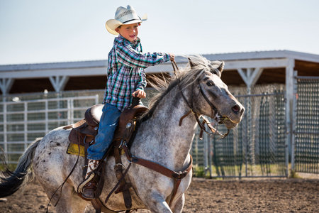 Rhett Michael (8) rides his horse, SuzyQ in the barrel race at the Youth Rodeo.
